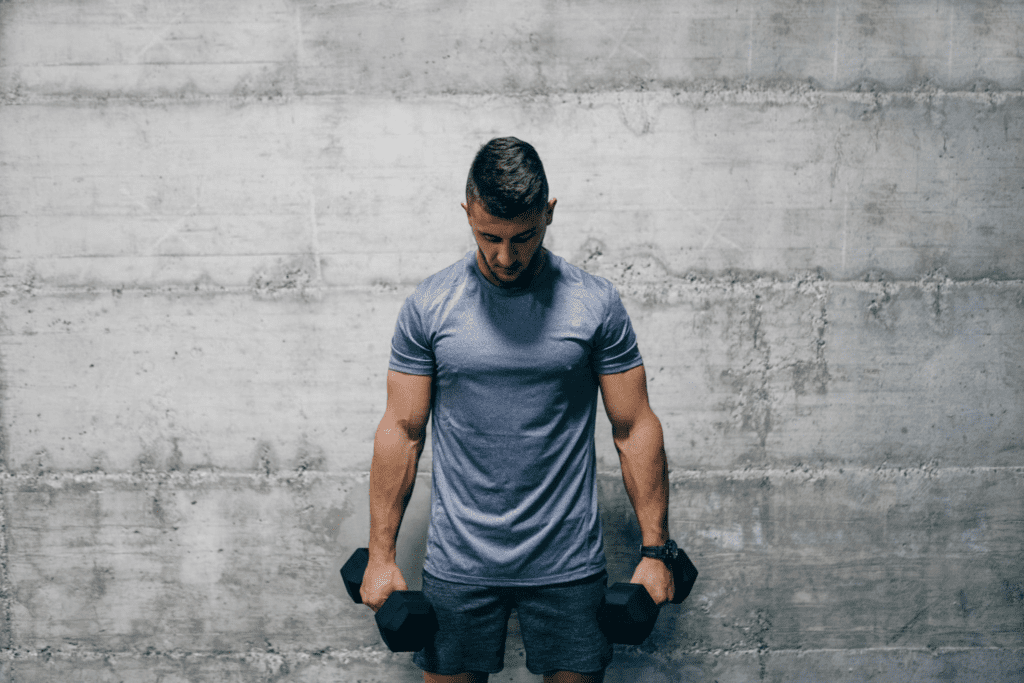 Man holding heavy dumbbells for grip endurance training